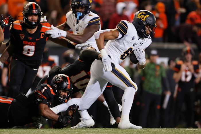 Nov 12, 2022; Corvallis, Oregon, USA; California Golden Bears running back Jaydn Ott (6) is tackled by Oregon State Beavers defensive back Alex Austin (5) during the first half at Reser Stadium. Mandatory Credit: Soobum Im-USA TODAY Sports